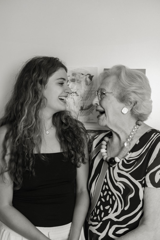 A business owner and a caregiver laughing together